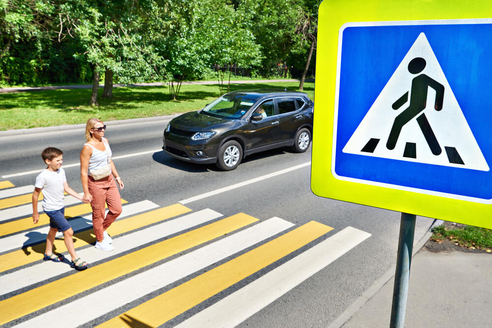 Woman and child using a pedestrian crosswalk in Smyrna.